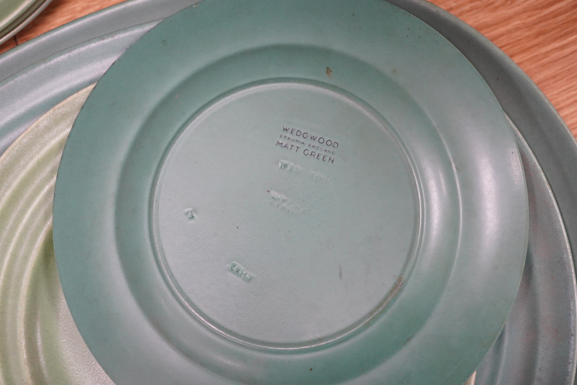 Keith Murray for Wedgwood, Annular part service comprising plates and two oval serving dishes, largest 38cm wide